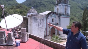 Hernán Garza shows the satellite dish on the roof of the Telecomm office in rural Santiago Nuyoó